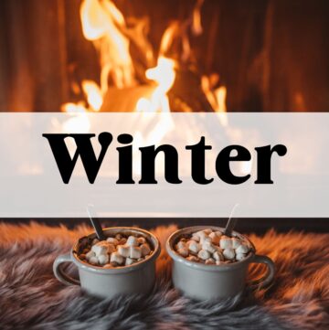 Hot cocoa cups by the fire with the word "winter" in text overlay.