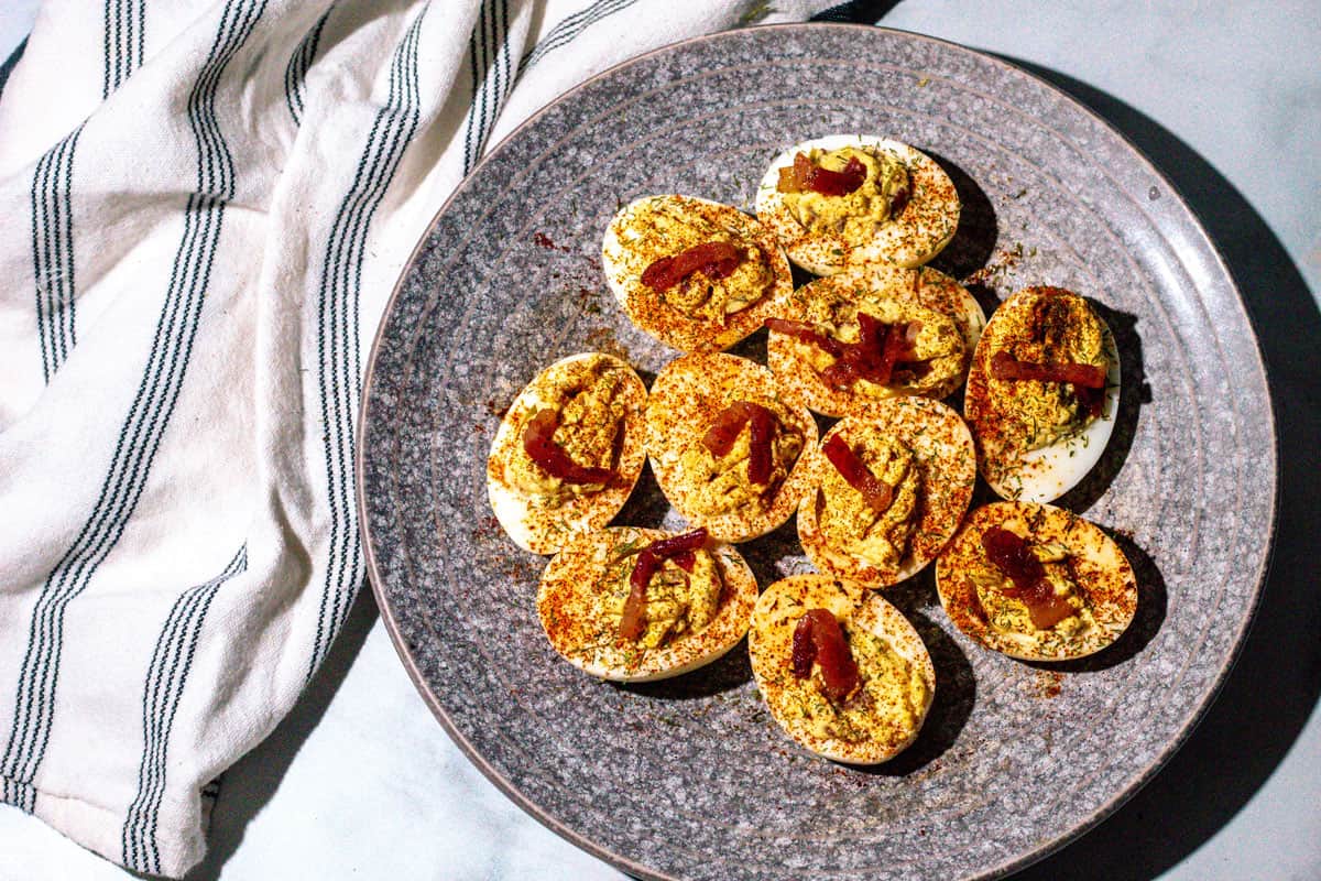 Deviled eggs on a gray plate.